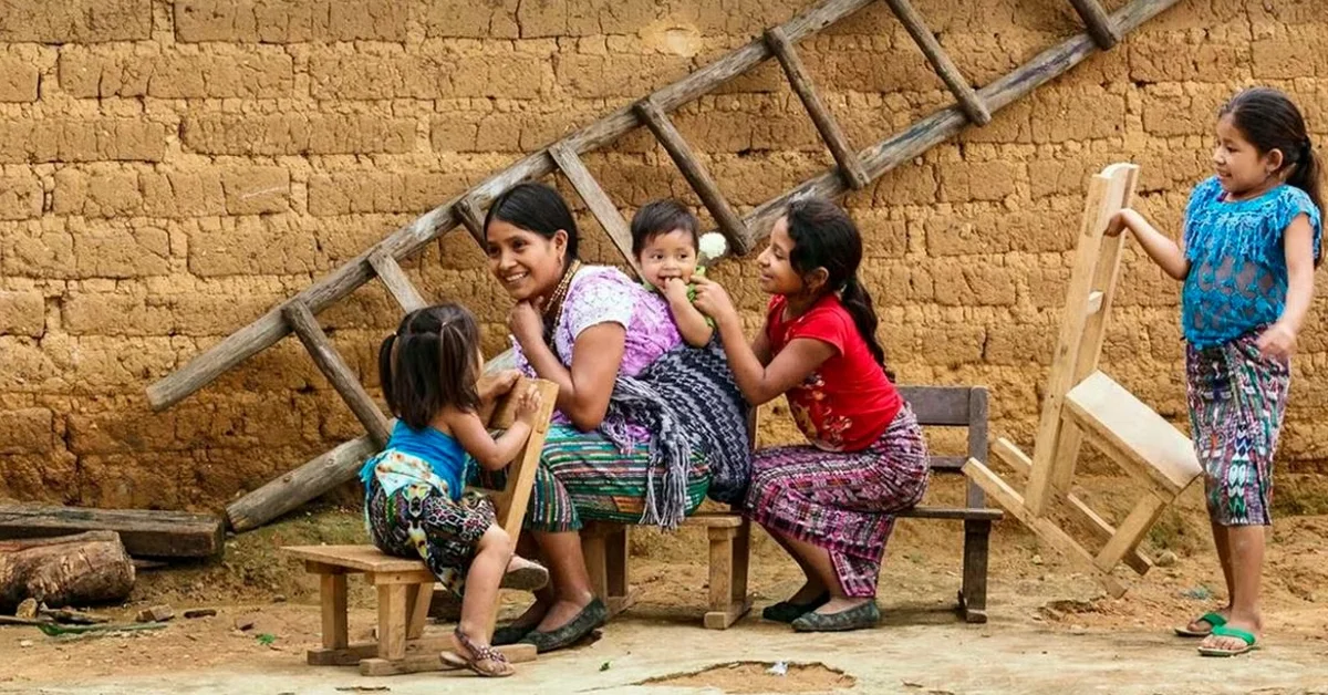 a woman sitting on a bench with children