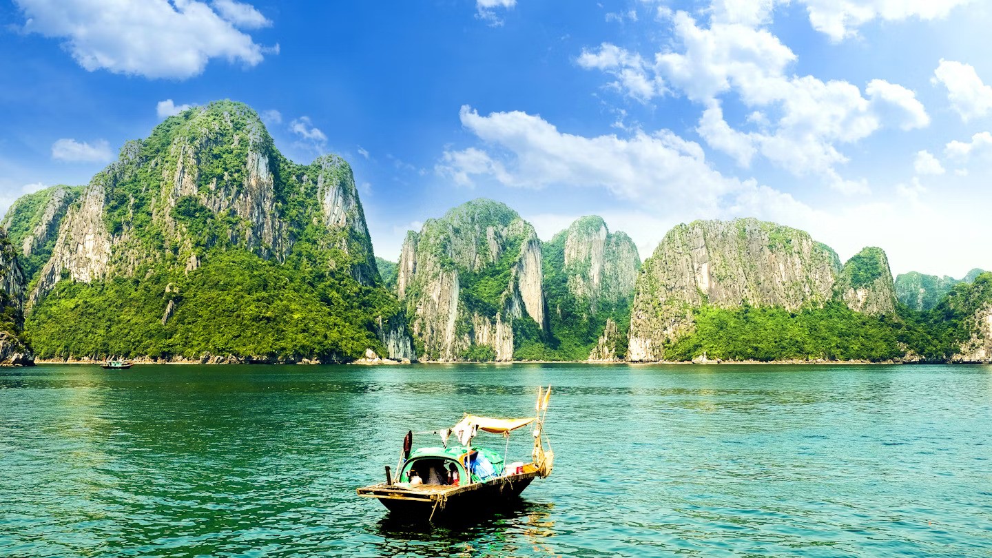 a boat in the water with mountains in the background