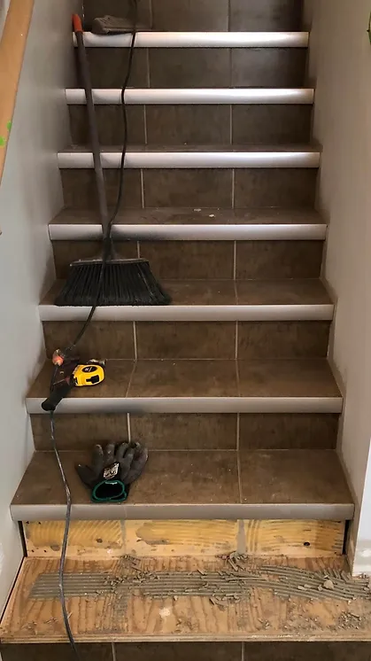 a broom and gloves on a staircase