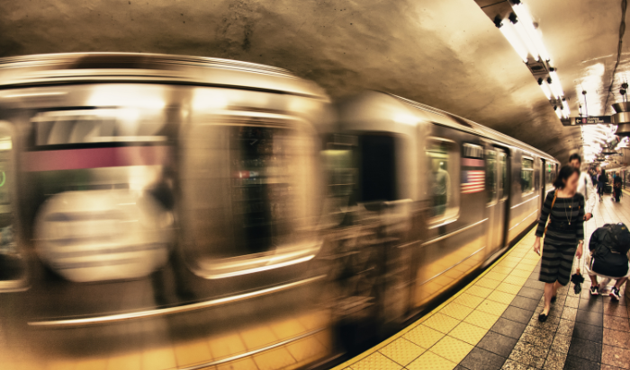 a blurry train in a subway station