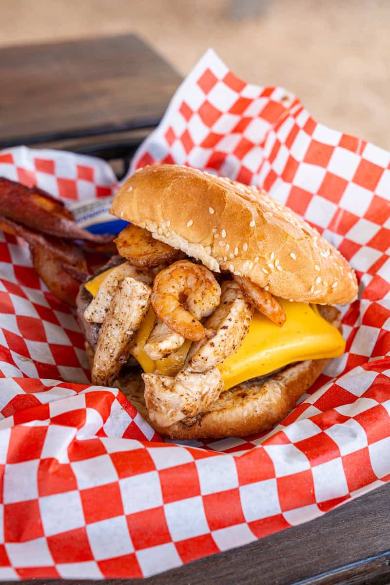 a burger with shrimp and bacon