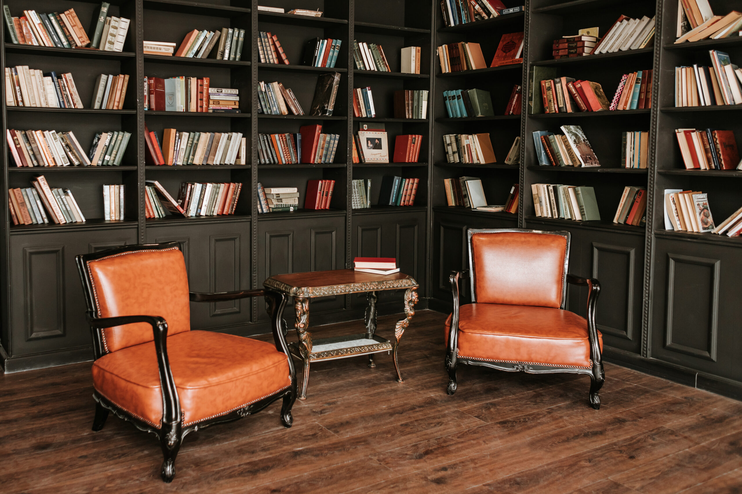 a chair and table in a room with bookshelves