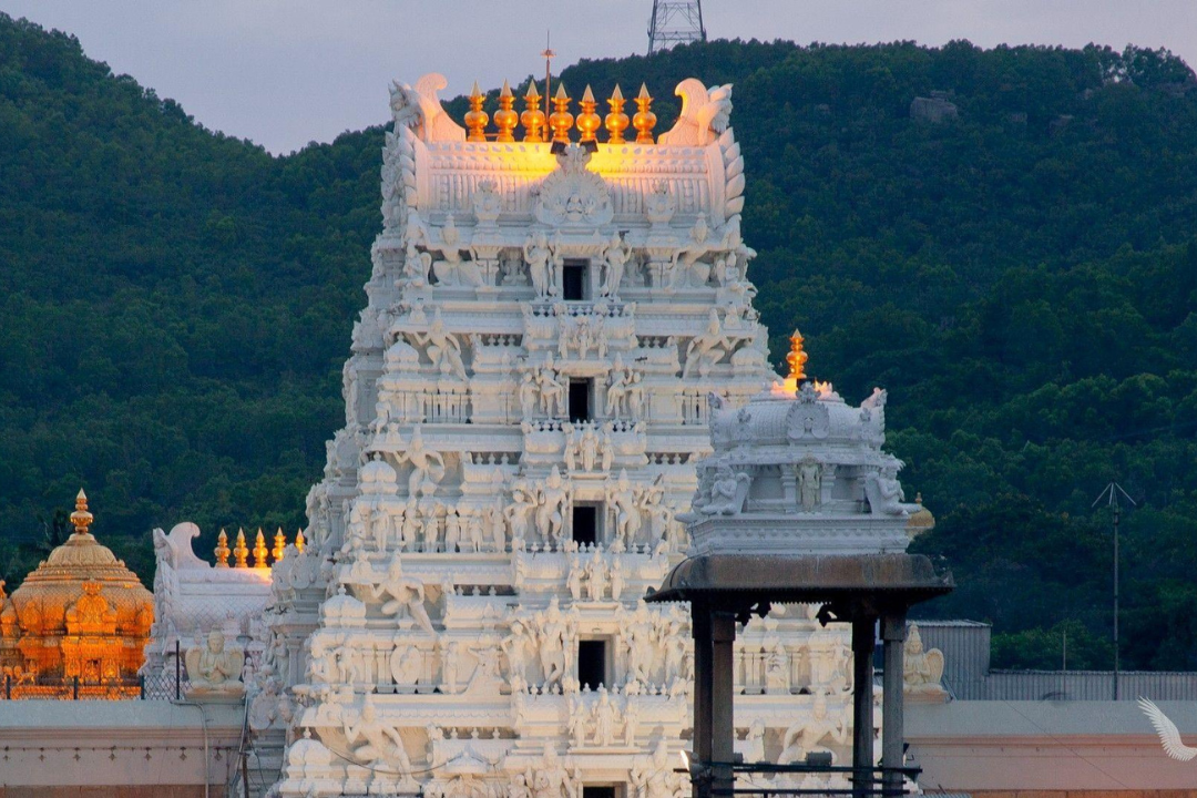 a white building with sculptures on top