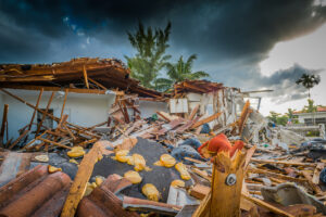 a destroyed building with debris and trees