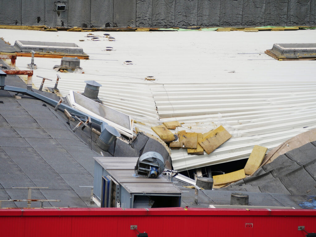 a roof of a building with a damaged roof