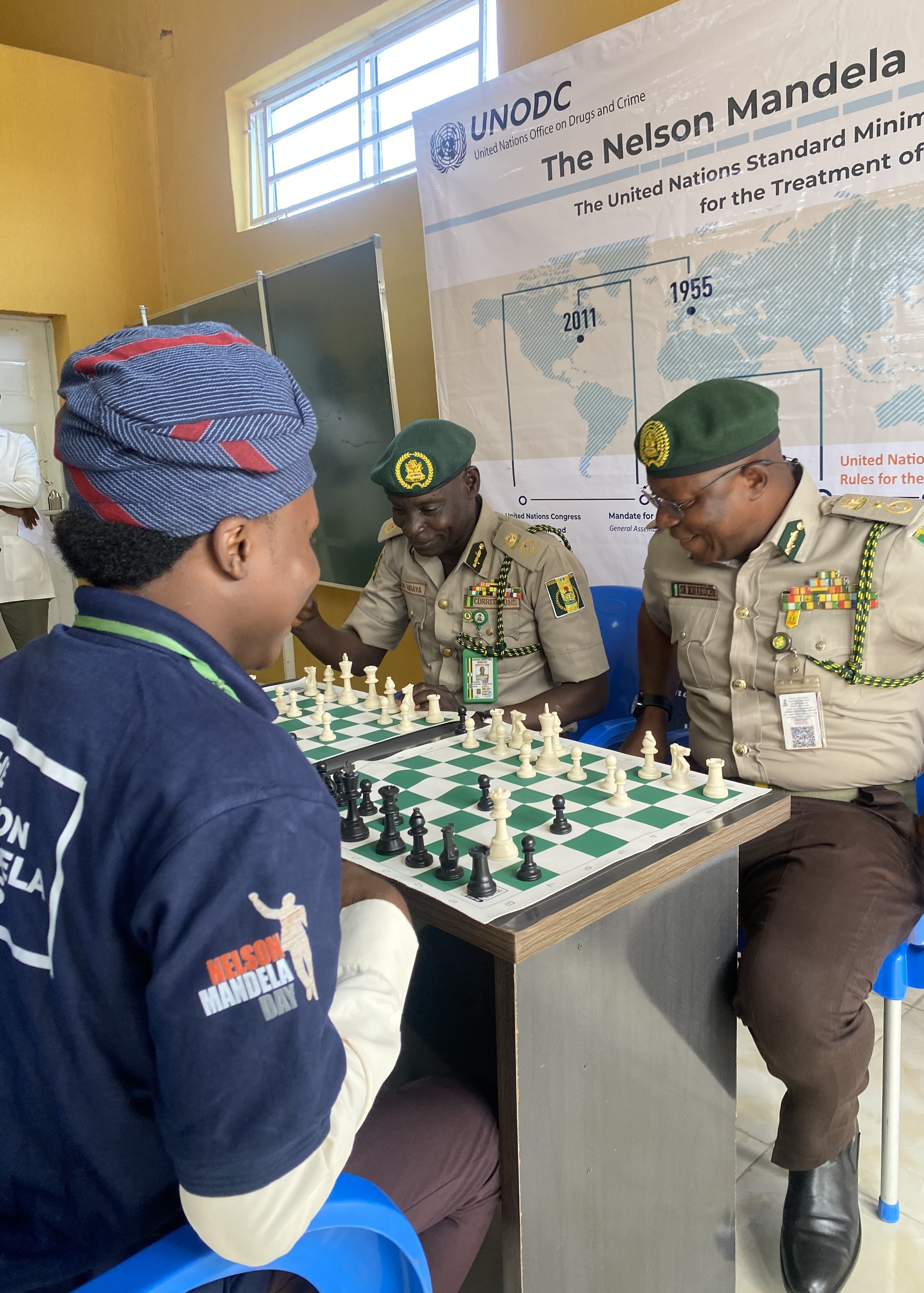 a group of men in uniform playing chess