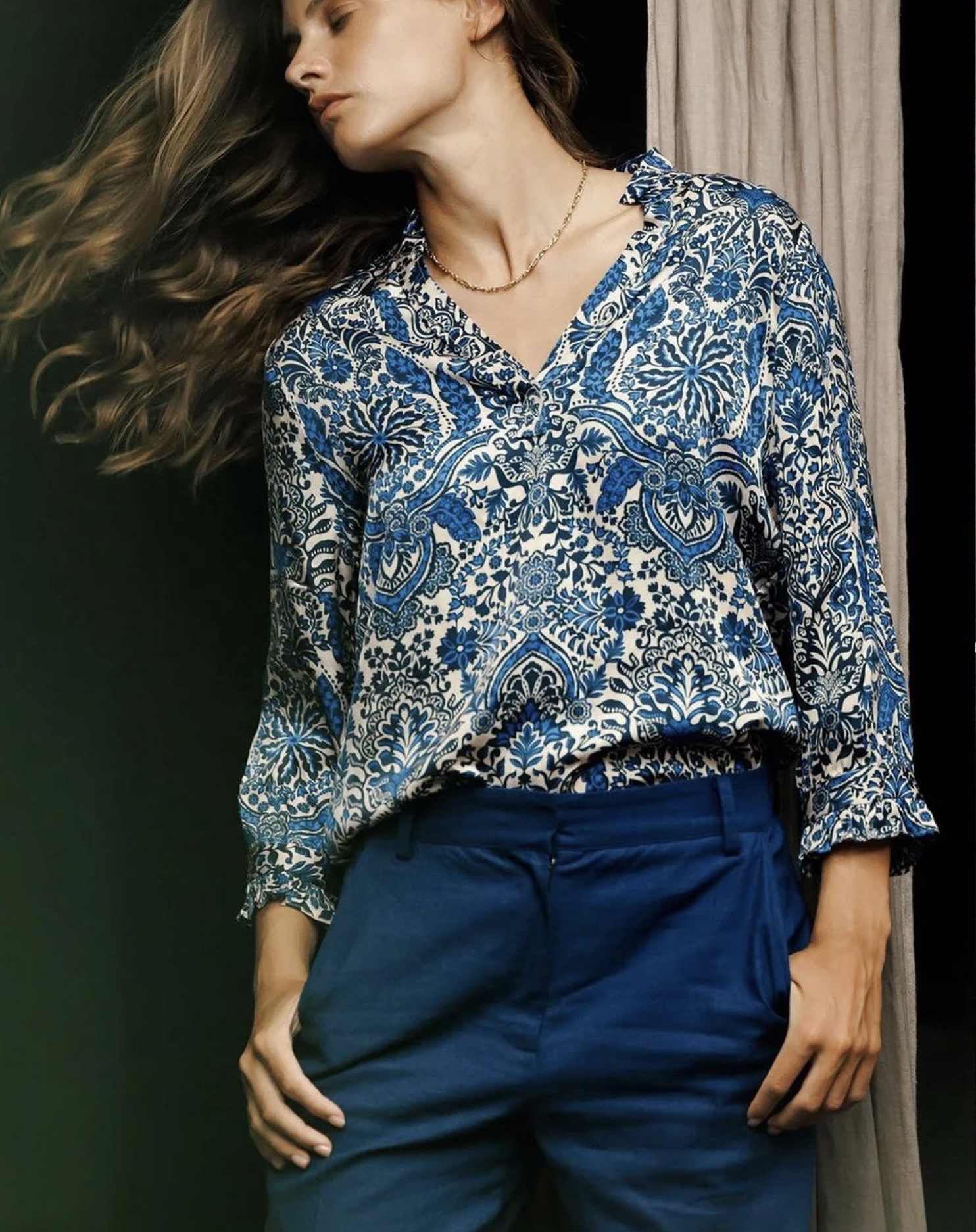 a woman in a blue and white patterned shirt