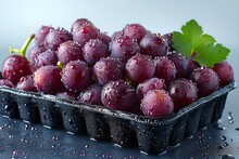 a tray of grapes with leaves