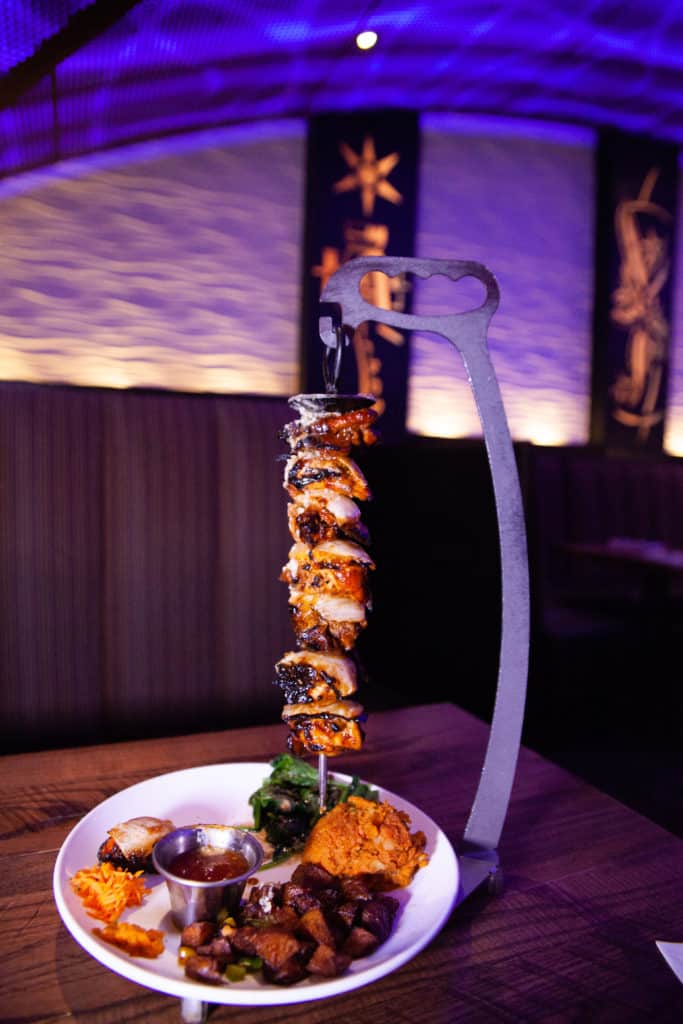 a skewer of meat on a plate