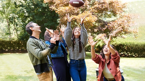 a group of people throwing a football