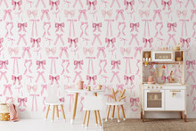 a room with a white table and chairs and a white cabinet with pink bows on the wall