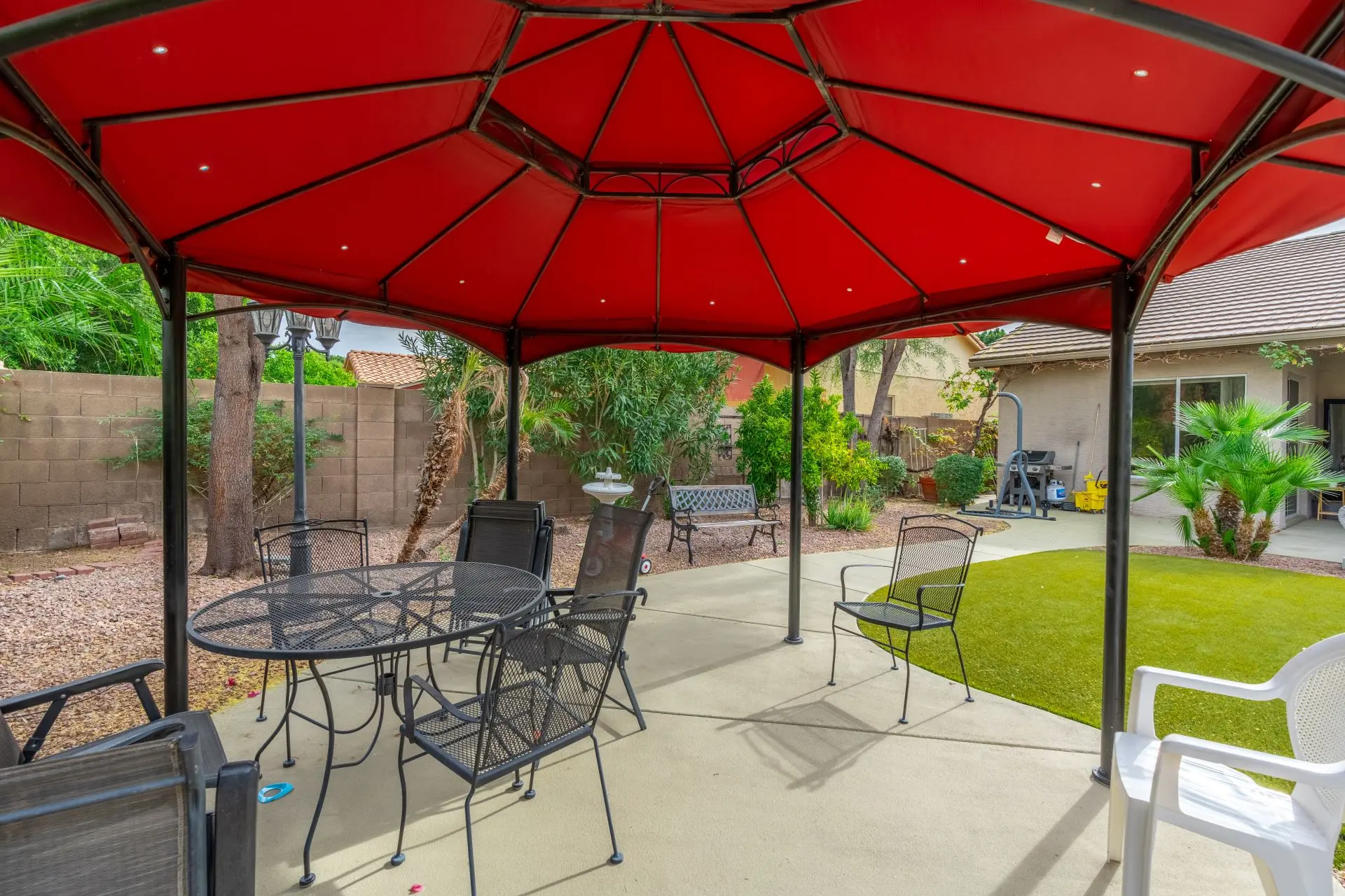 a patio with a red canopy