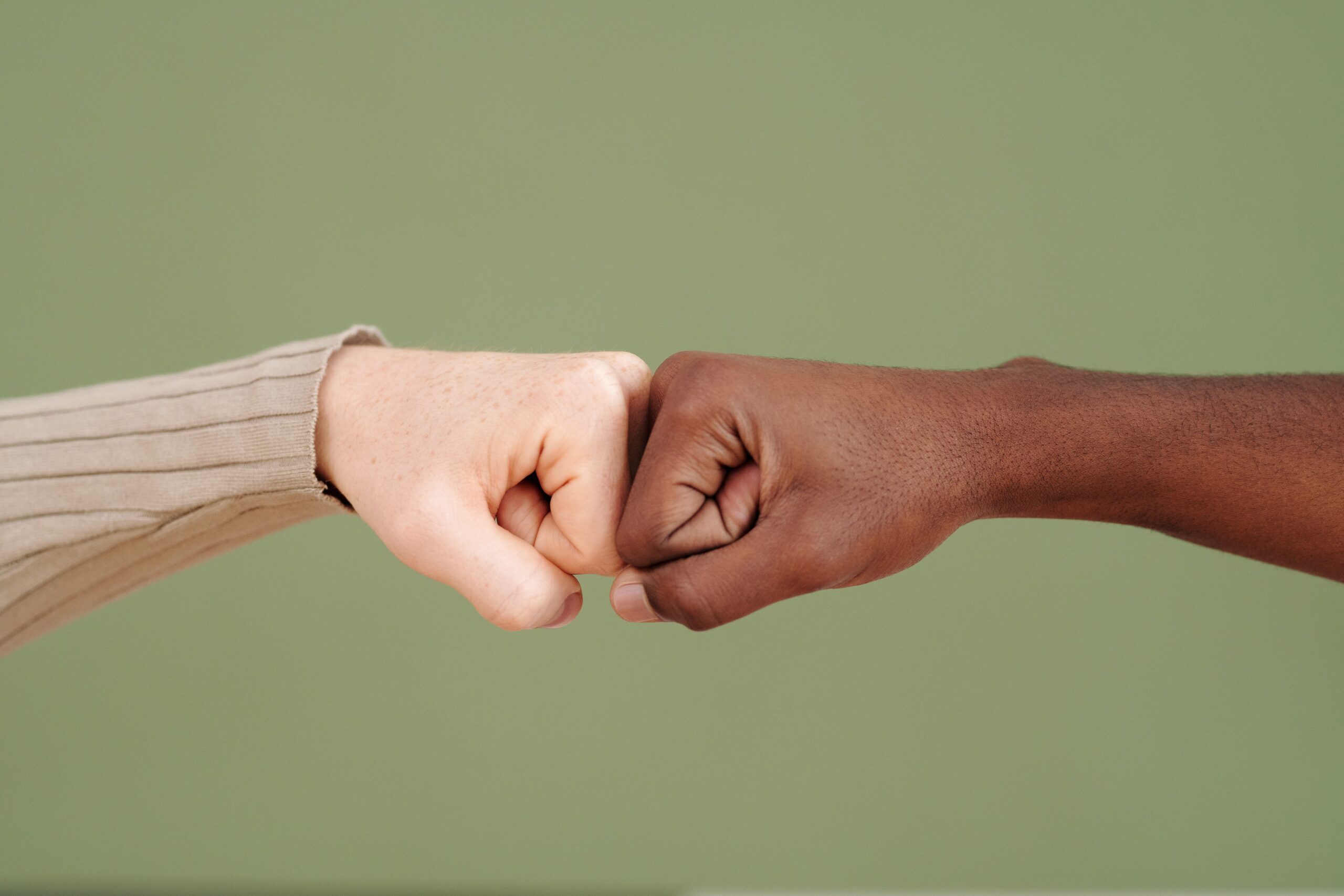 a close-up of a fist bumping