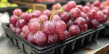 a bunch of grapes in a black container