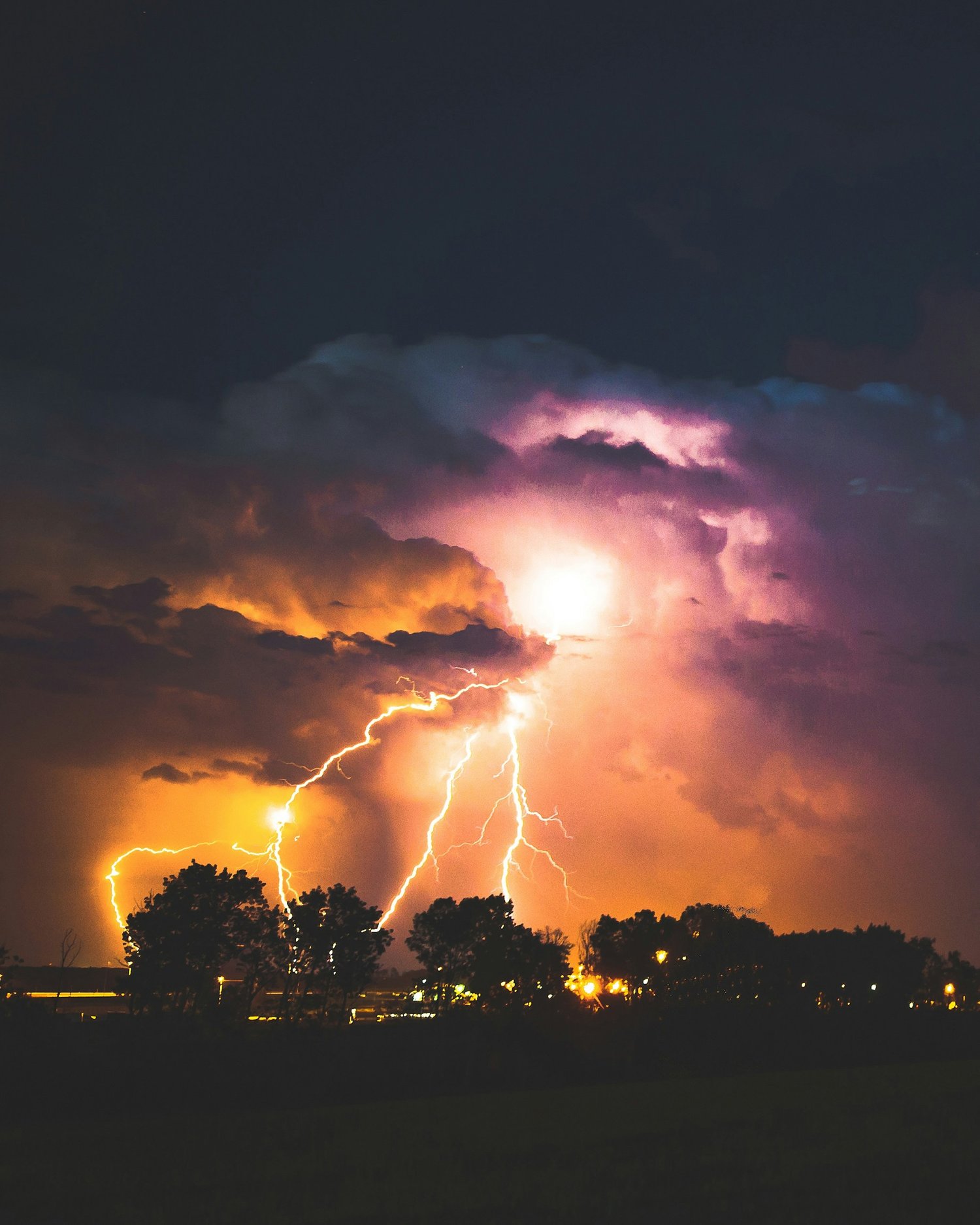 lightning striking trees in the sky