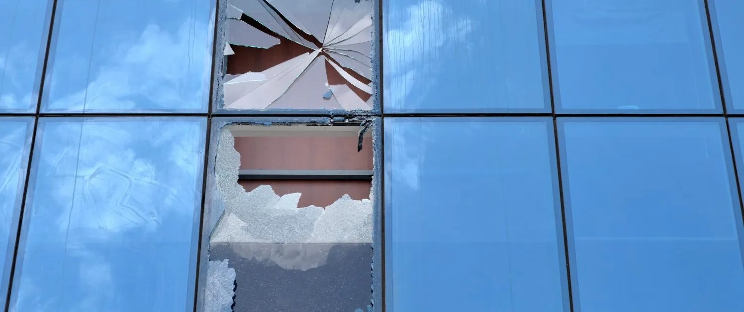 a broken window with blue glass