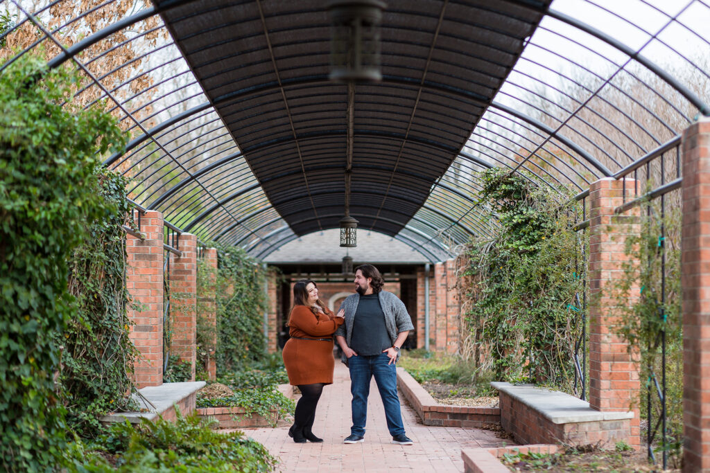 a man and woman standing under a covered walkway