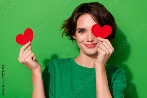 a woman holding a heart over her eyes