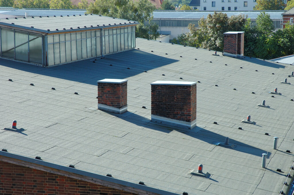 a roof with chimneys and trees