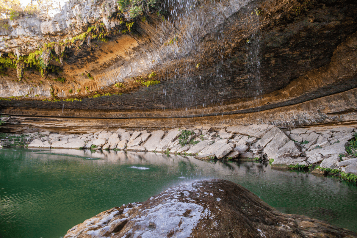 a water fall over a rock wall