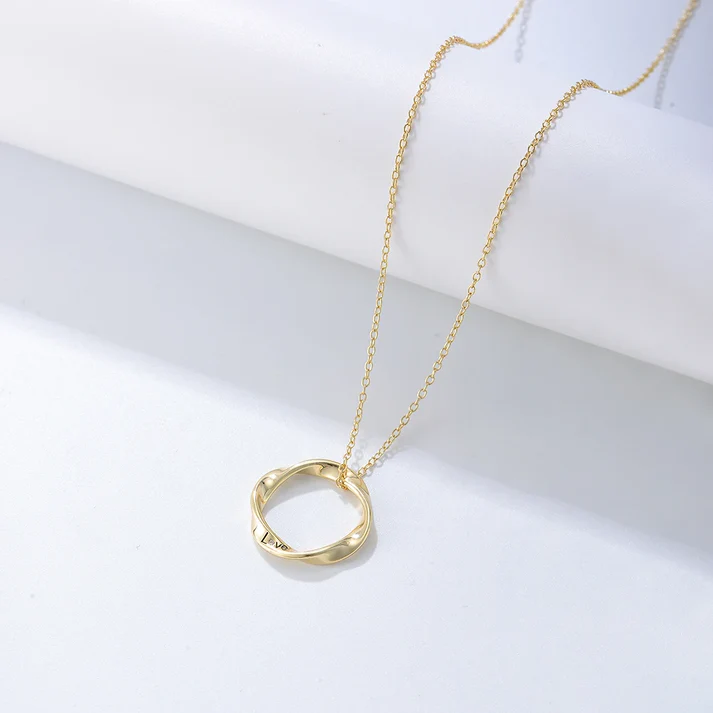 a gold necklace with a ring on it