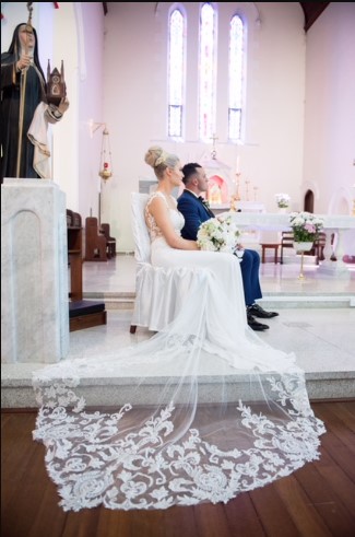 a bride and groom sitting in a church