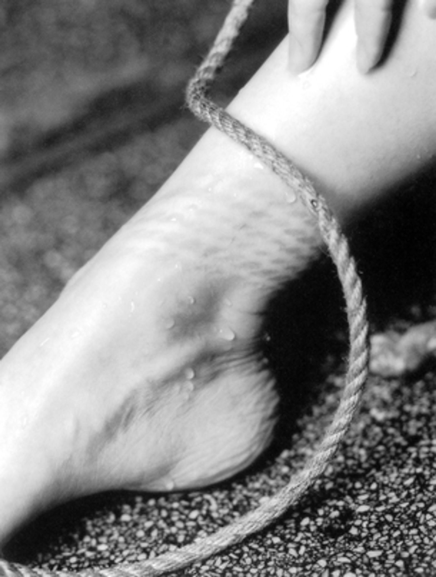 close-up of a foot with a rope around it