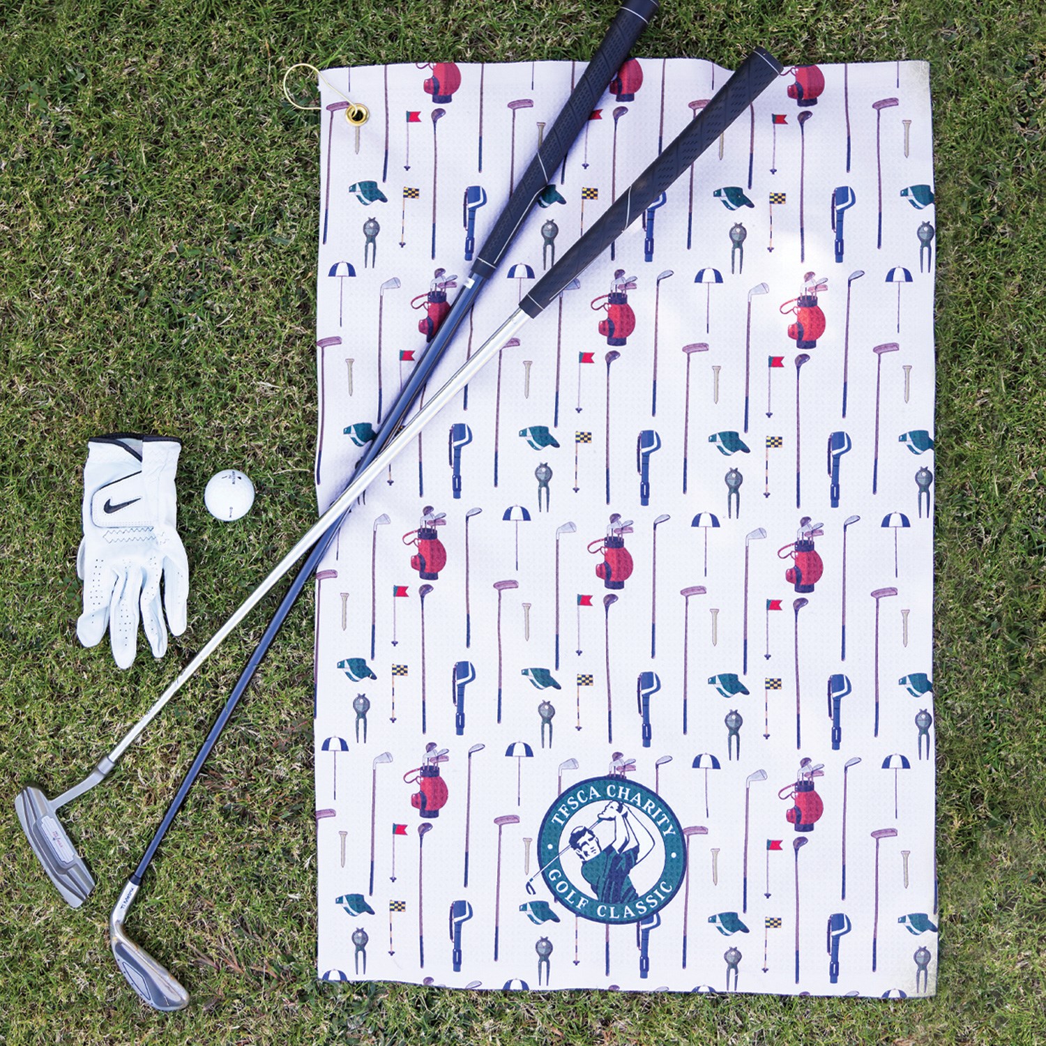 a golf clubs and a golf ball on a towel