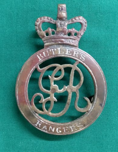 a metal badge with a crown and text