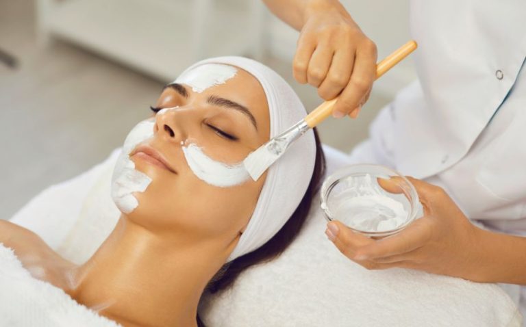 a woman getting a facial mask treatment