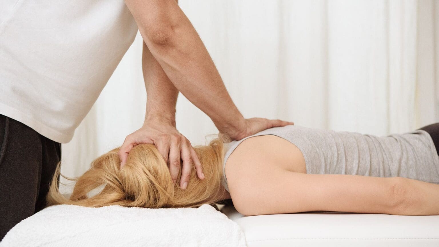 a person massaging a woman's head