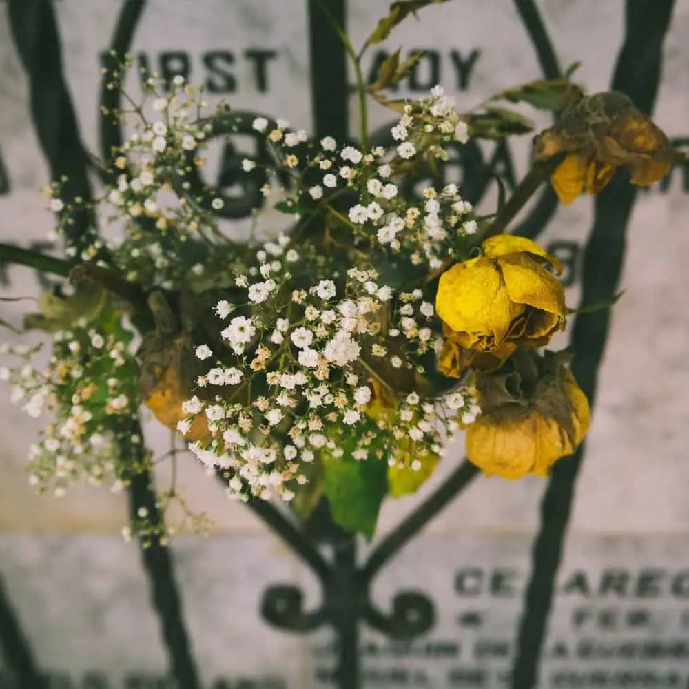 a bouquet of flowers on a fence