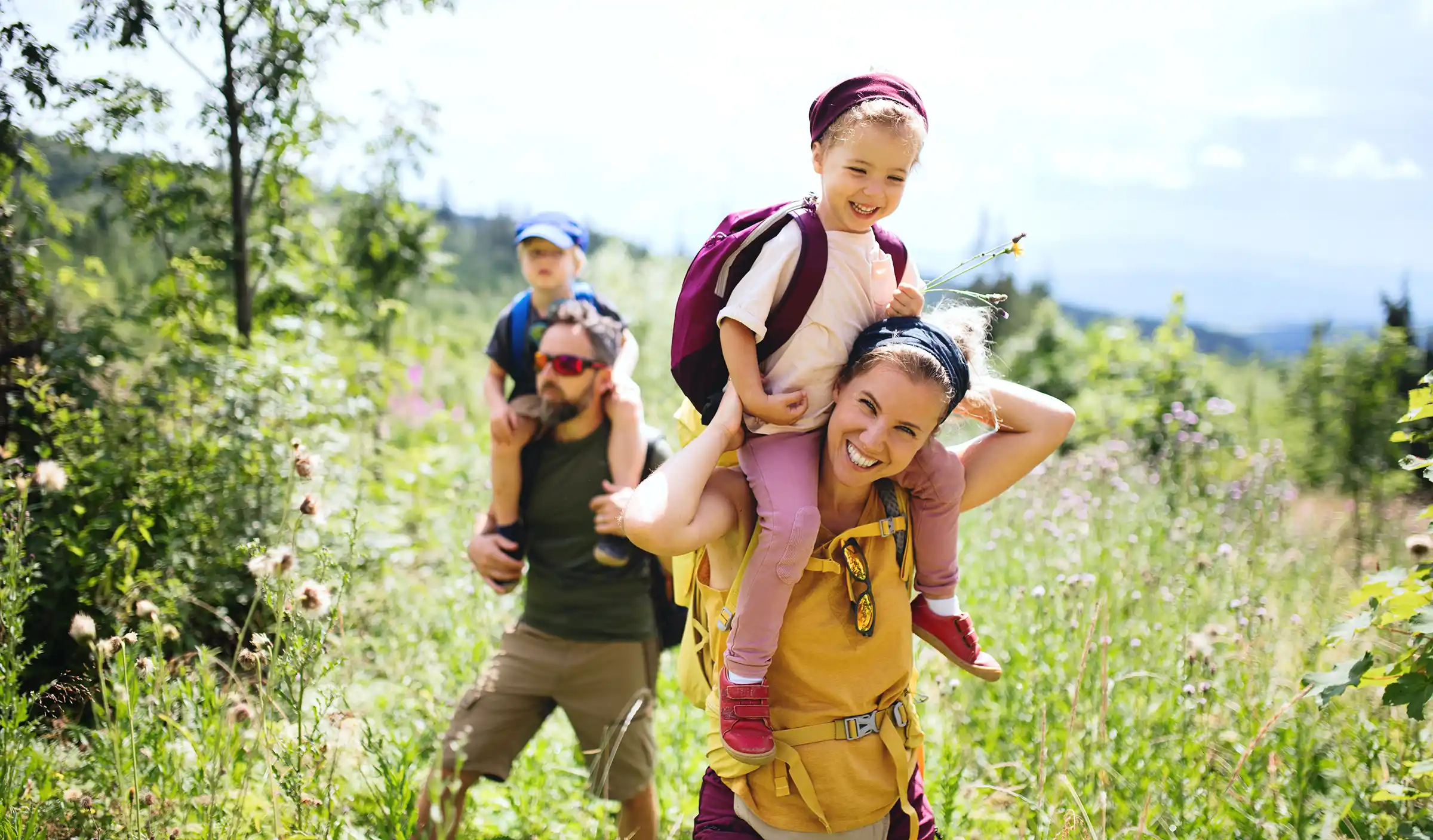 a woman carrying a child on her back