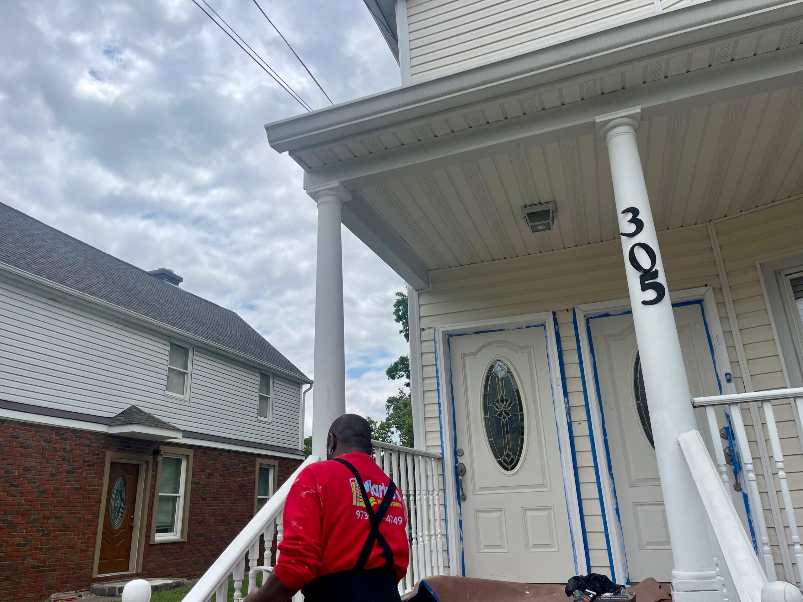 a man standing on a porch of a house