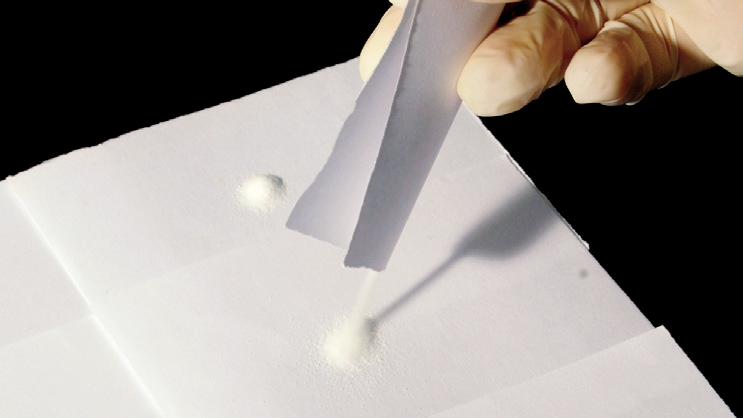 a person pouring powder into a white object