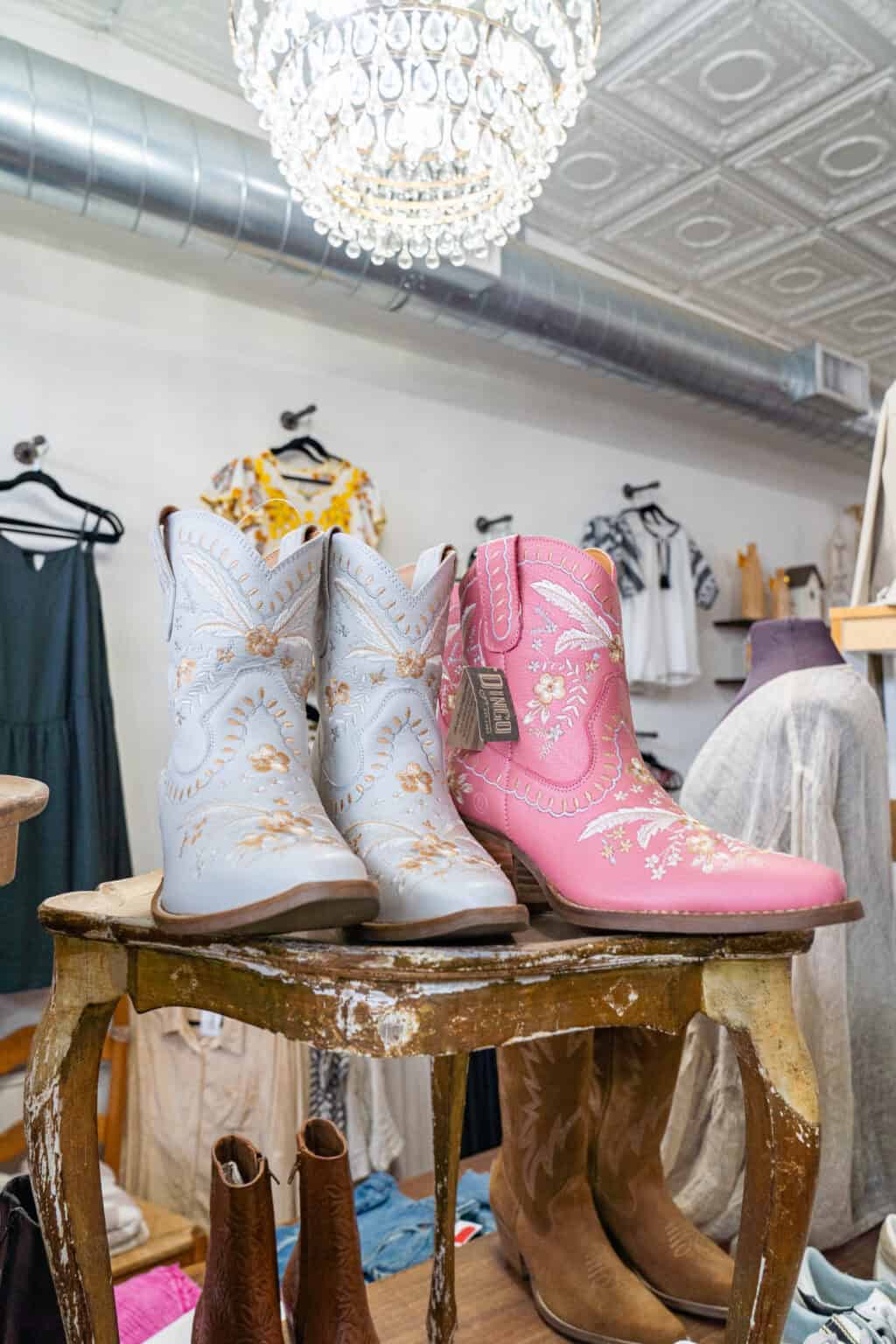 a pink and white cowboy boots on a stool