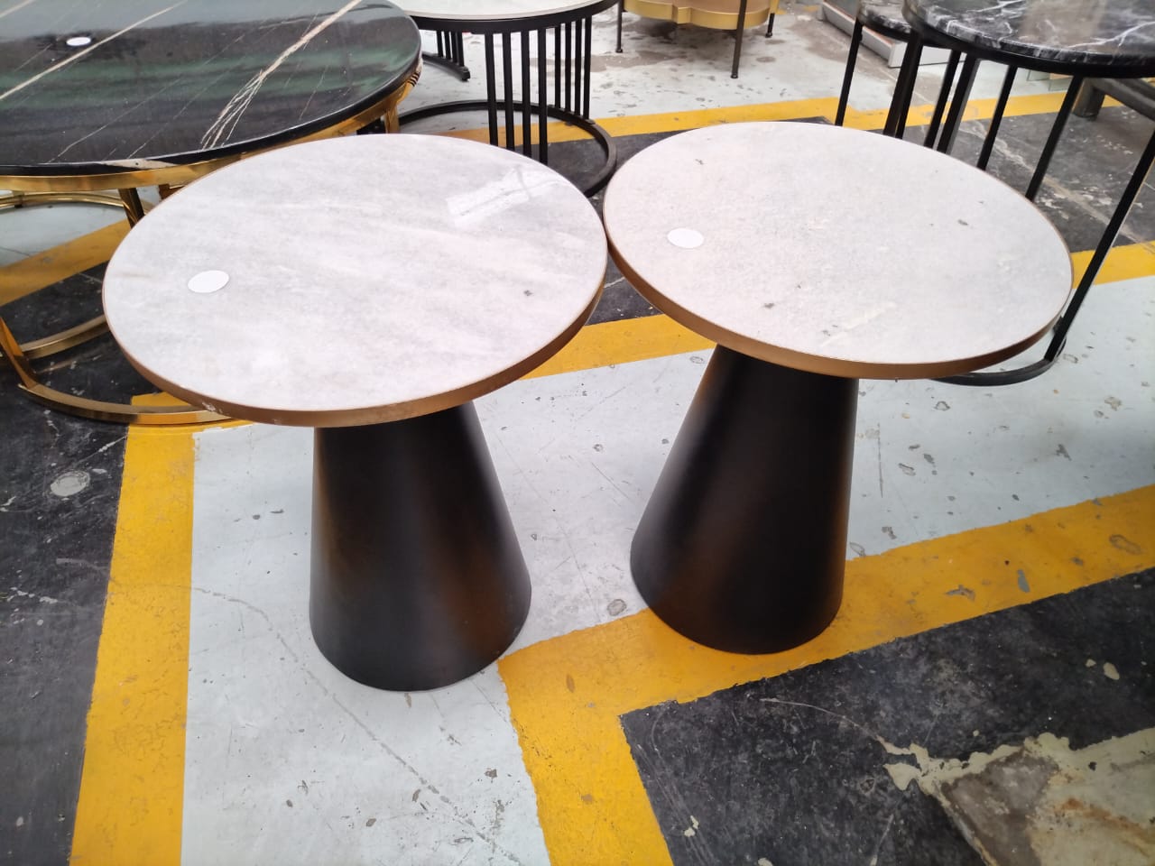 a group of tables on a yellow and white floor