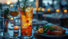 a glass of ice tea with berries and a plate of fruit on a table