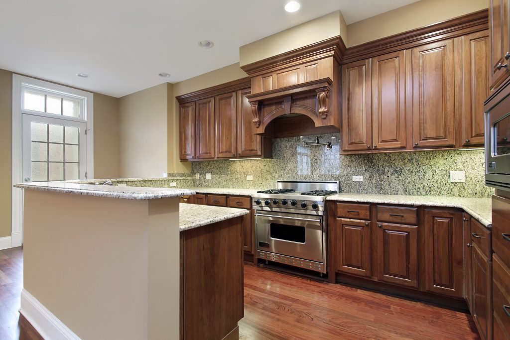 a kitchen with granite counter tops and a stove