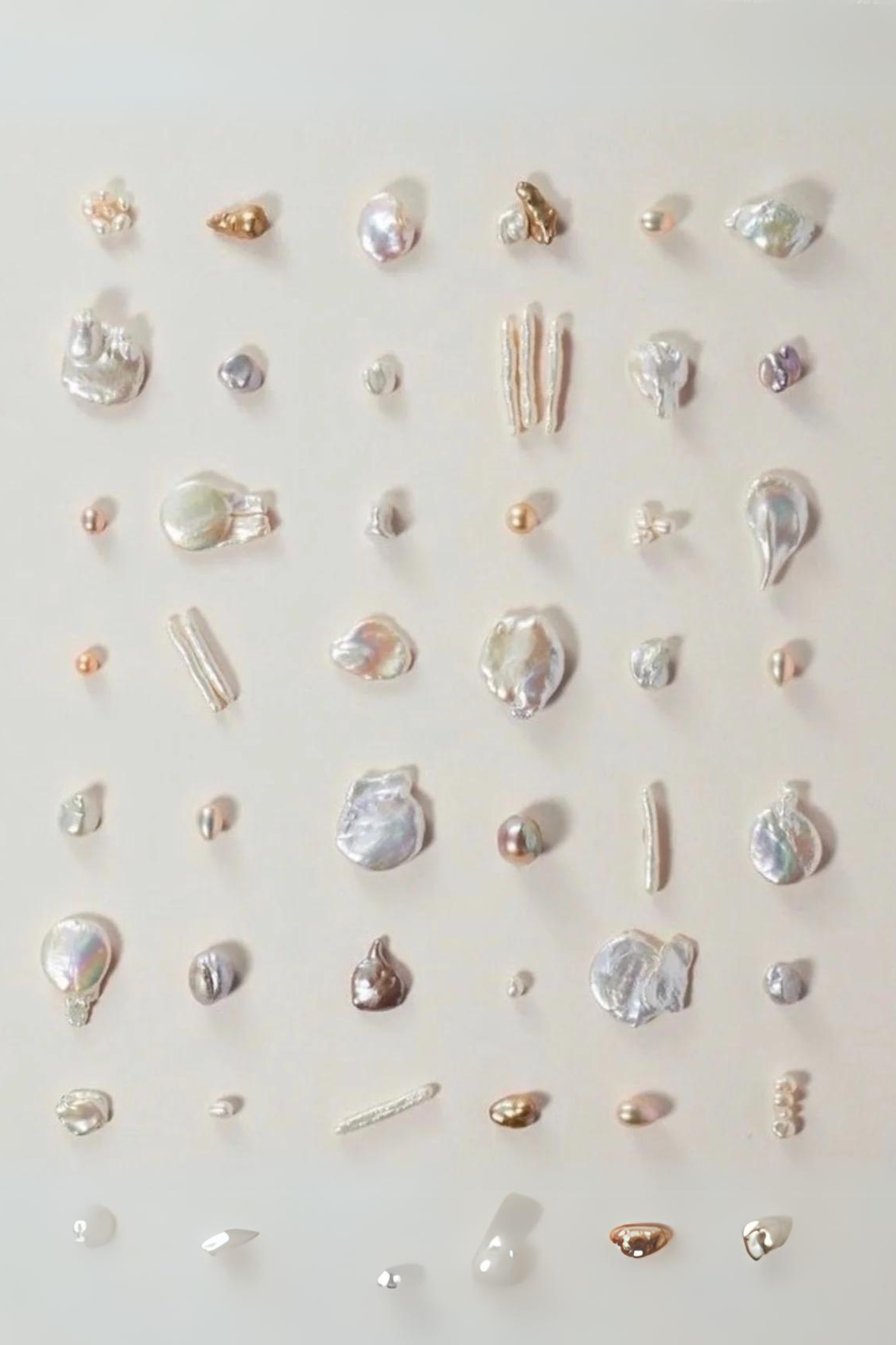 a group of pearls on a white surface