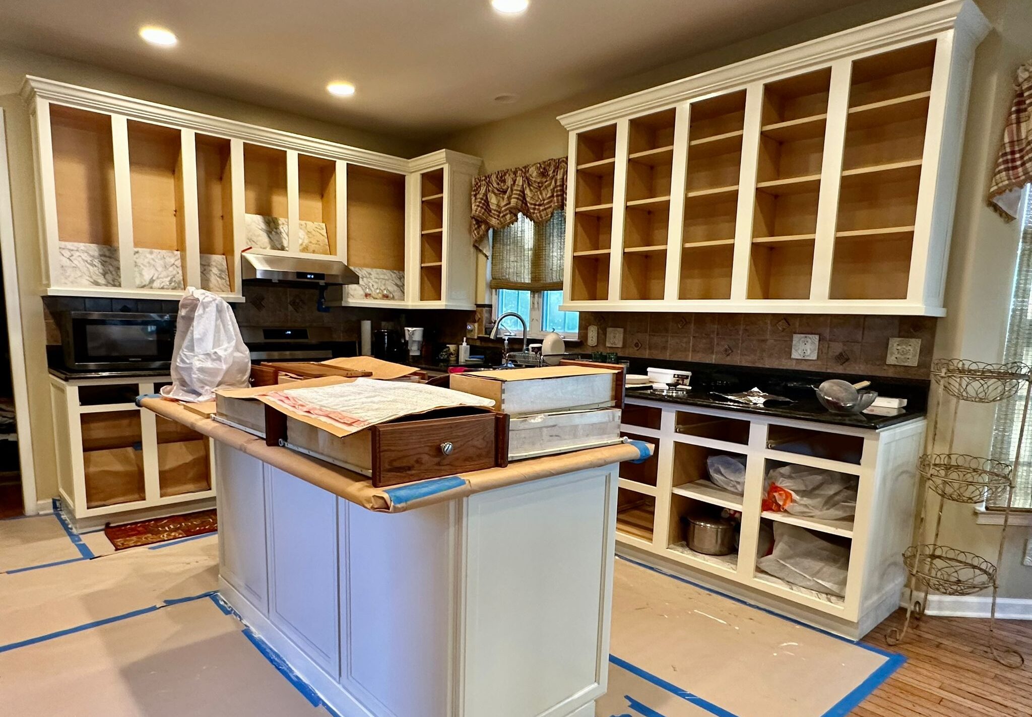 a kitchen with white cabinets and a island