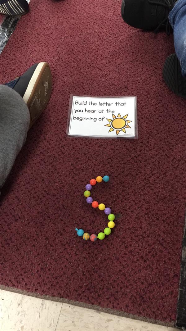a sign and a bracelet on the floor