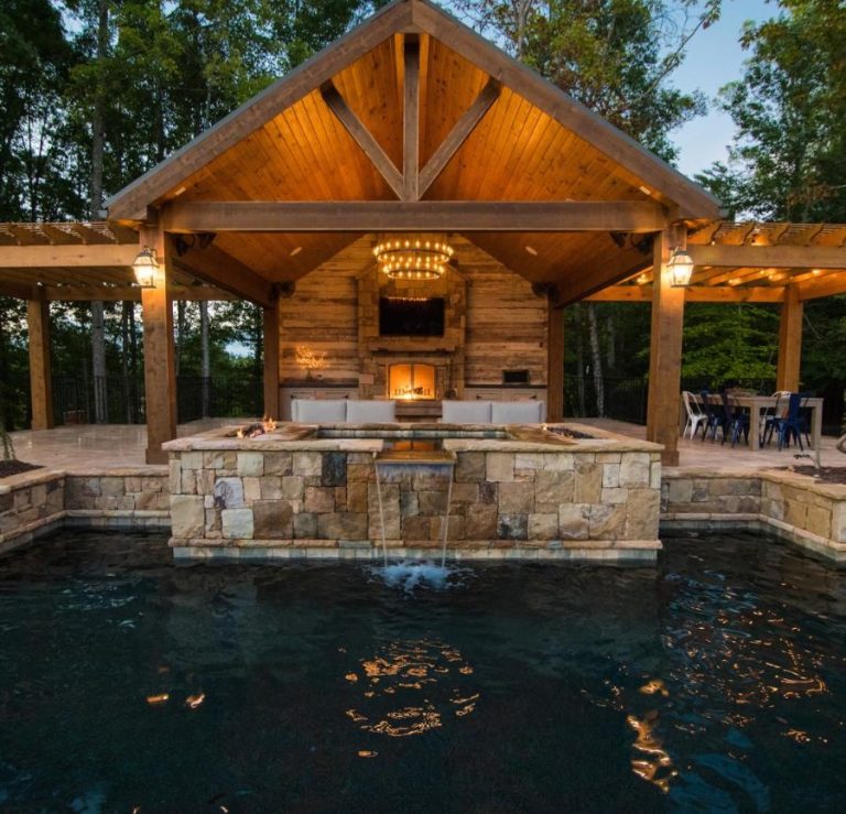 a pool with a waterfall and a gazebo