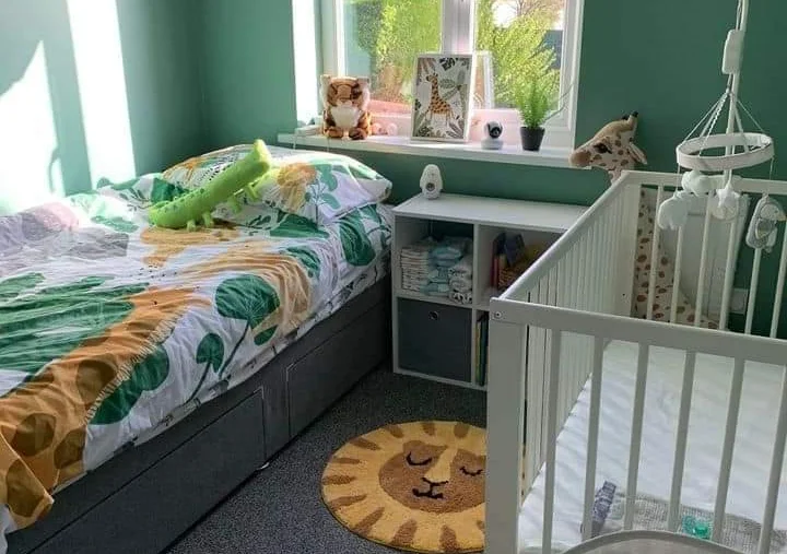 a room with a crib and a bed