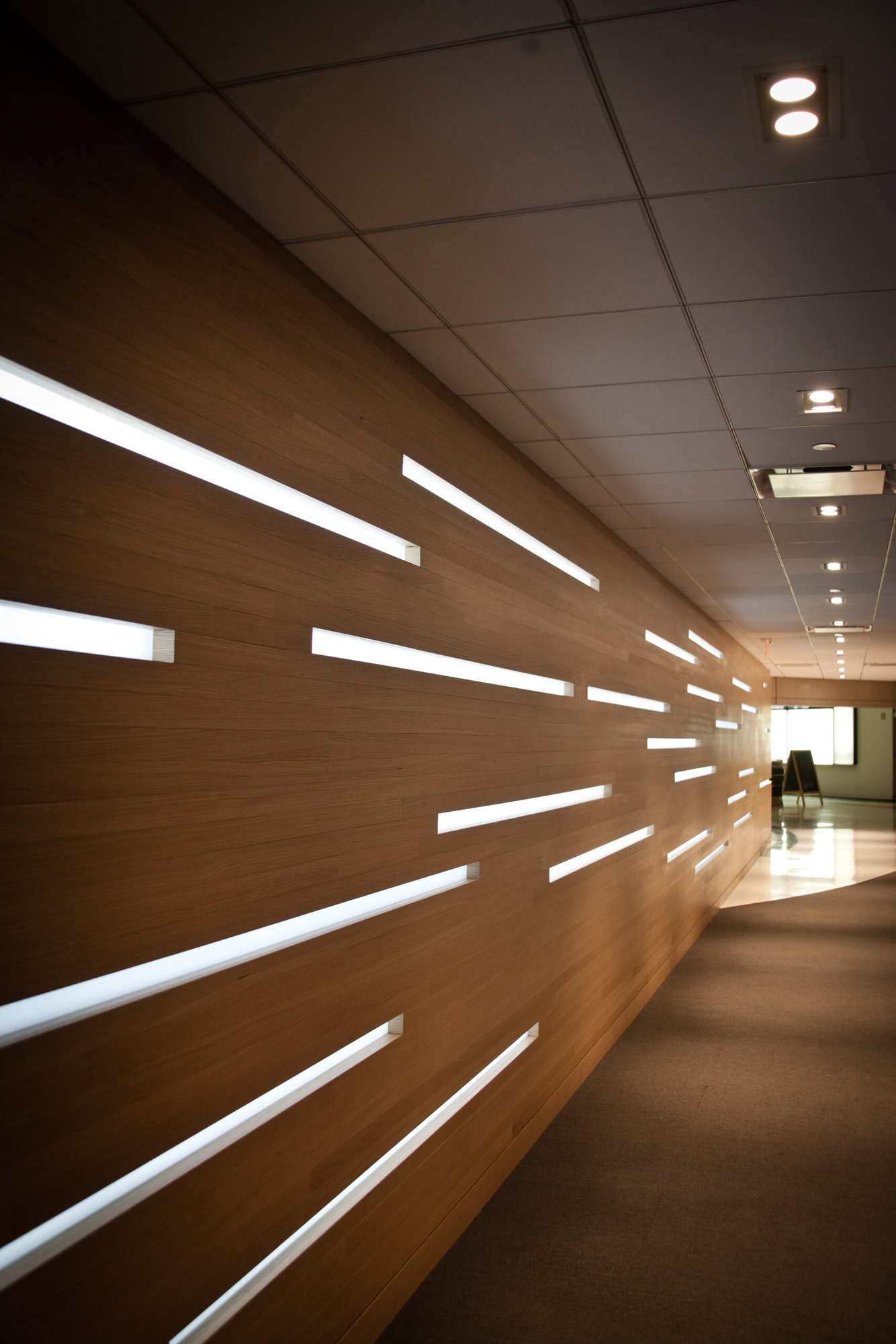 a hallway with lights on the wall