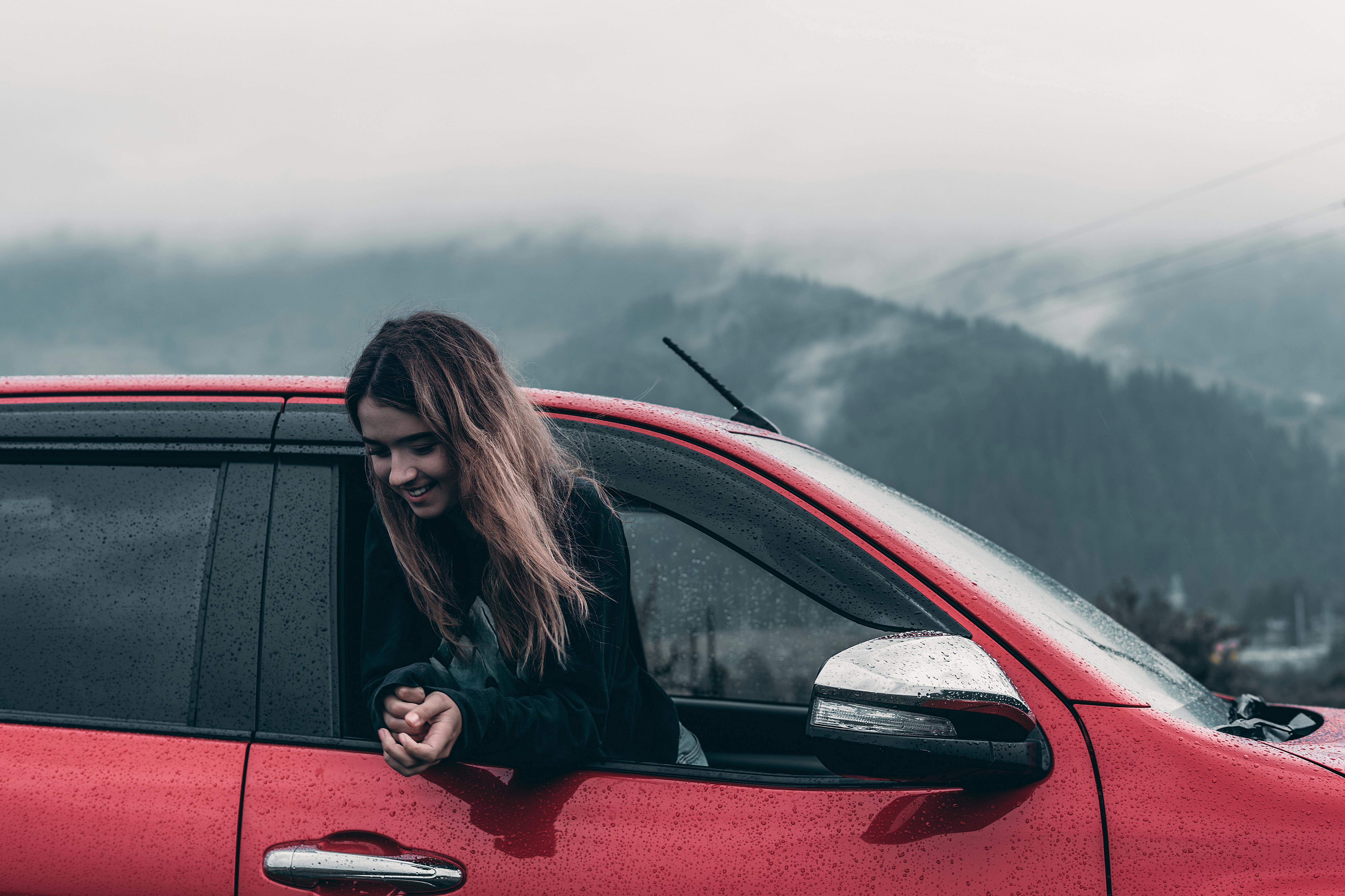 a woman looking out of a car window