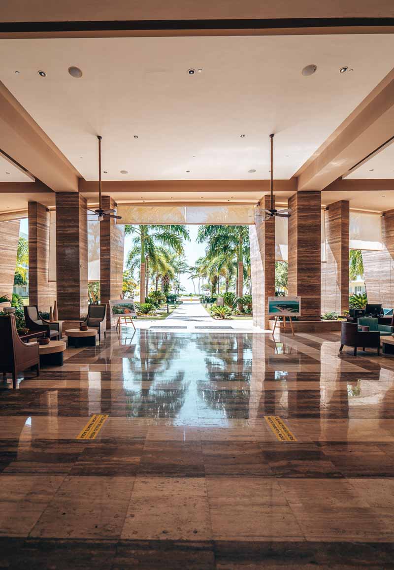 a lobby with chairs and trees