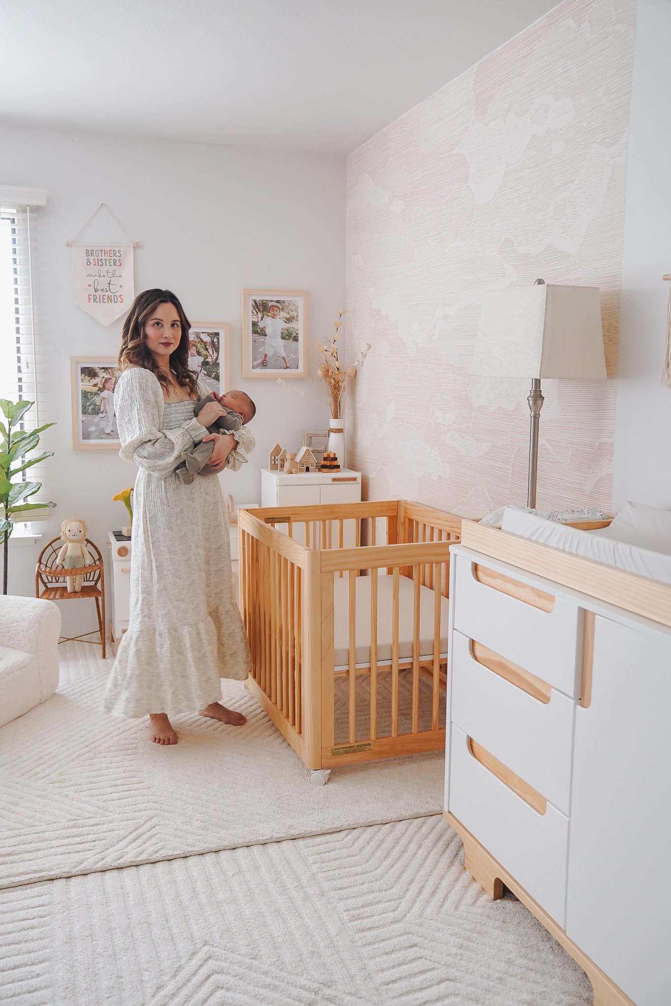 a woman holding a baby in a nursery