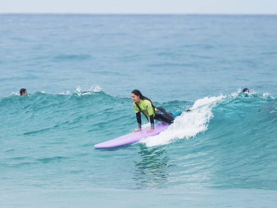 a woman on a surfboard in the ocean