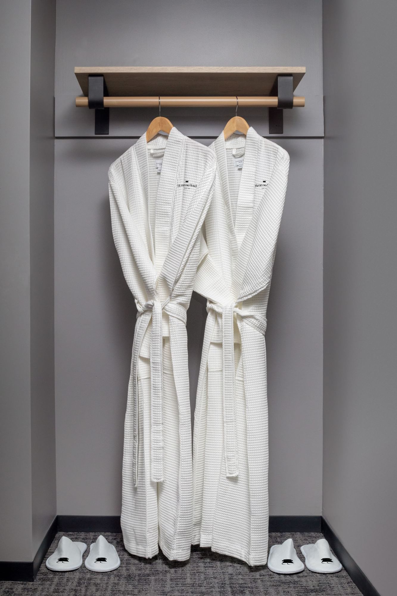 a pair of white robes on a rack